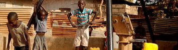 Kids fetching water at the village water pump.